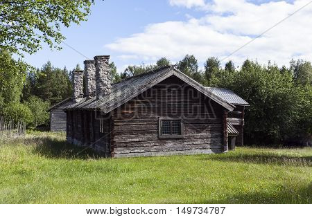 HARJEDALEN, SWEDEN ON JULY 07. View of an old homestead in the countryside on July 07, 2016 in Harjedalen, Sweden. Building in log, timber surrounded by farmland and forests. Editorial use.