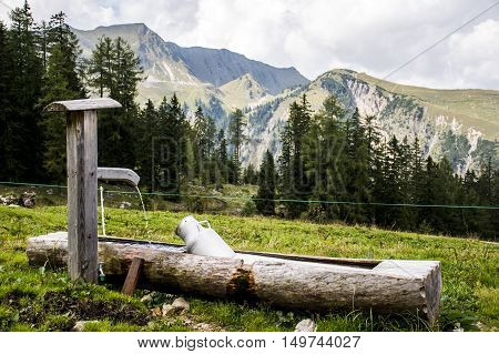 A Water and feeding trough in Austria, Seekaralm near the Achensee with mountains