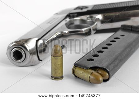 Pistol and ammunition on the white background.