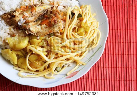 Close up of cooked chicken dish with rice noodles and olluco in Peru