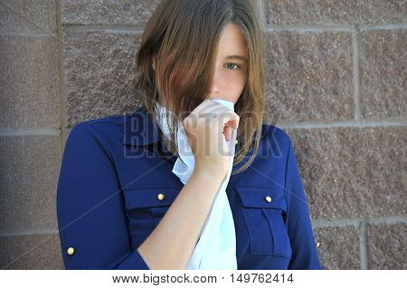 Mature female nanny expressions against a wall outside.