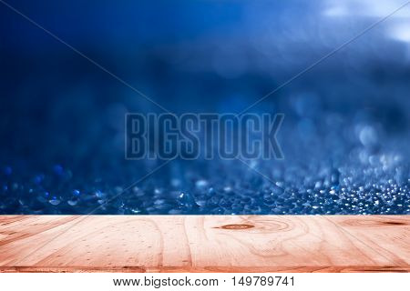 empty wood and dark blue blurred background / can be used display your product or art work