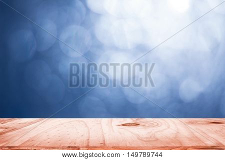 empty wood and dark blue blurred background / can be used display your product or art work