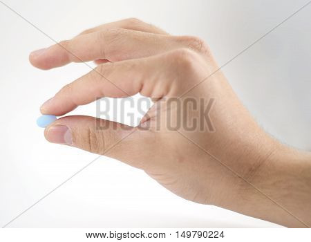 Male Hand With Blue Pills