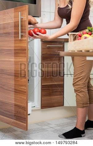 Woman Loading Tomatoes In The Larder