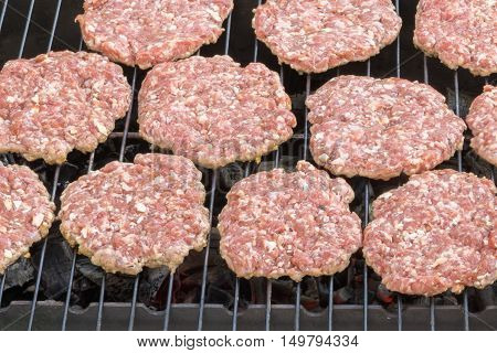 burgers hamburger fried on the grill over hot coals
