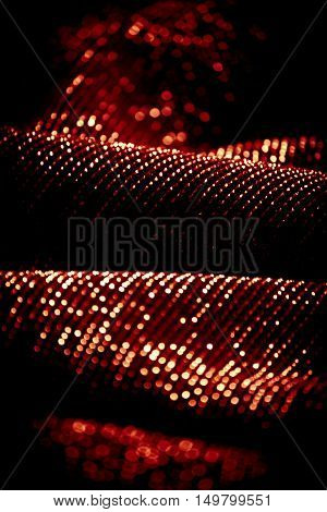 draped lurex fabric - warm red orange color space - dark background