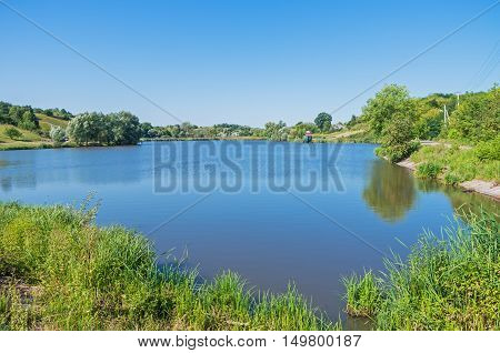 View of the pond in clean rural midday in late August
