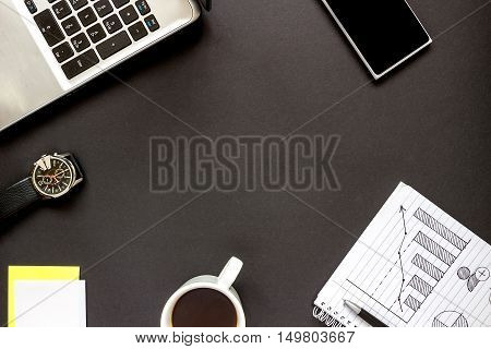 Office desk with notepad, smartphone, watch and coffee cup. Top view