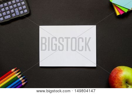 White Sheet Of Paper And Stationery On The Desk