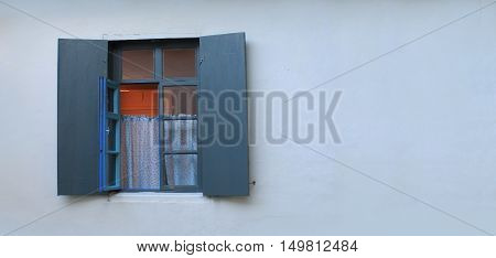 With open window shutters on the farmhouse.