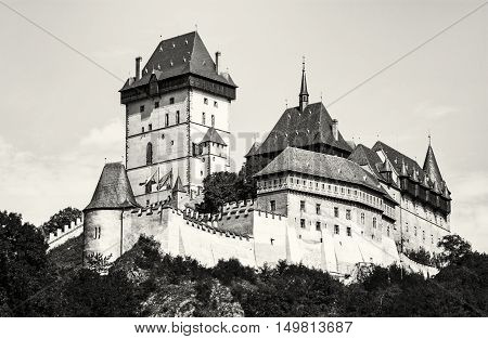 Karlstejn is a large gothic castle founded 1348 by Charles IV in Czech republic. Black and white photo. Ancient architecture. Travel destination. Beautiful place.