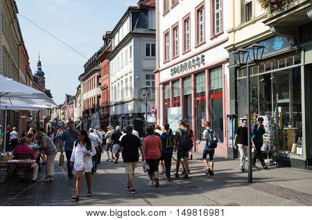 HEIDELBERG, GERMANY - SEPTEMBER 15: Tourists walking at the main street Haptstrasse in the old german city Heidelberg on September 15, 2016.