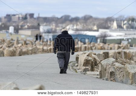 Fairhaven Massachusetts USA - January 1 2016: Dressed for a cold walk along the dike in Fairhaven Massachusetts on New Year's day