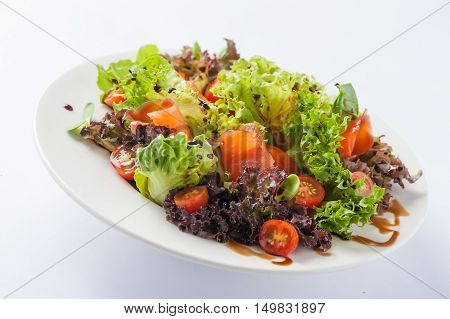 Modern style smoked salmon salad with balsamic dressing in ceramic dish