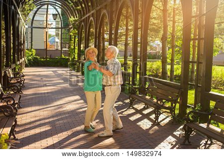 Senior couple is dancing. Smiling elderly woman. I feel young again. Movement is life.