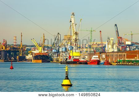 Cargo ship in the morning light on port of Gdansk Poland.