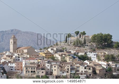 view of church saint peter apostle buildings and castle of polop de la marina