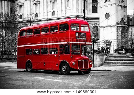 London's iconic red double decker bus on black and white background.
