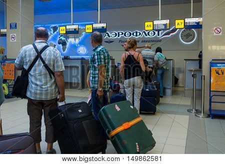 Simferopol, Russia - June 15, 2016: Passengers waiting for registration at the counter of airline 