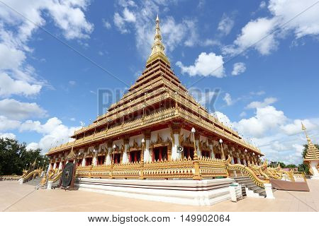 Thailand Buddhist temple golden stupa in Khonkaen of landmarkTemple in Khon Kaen have local name is Wat Nong Waengon blue sky background.