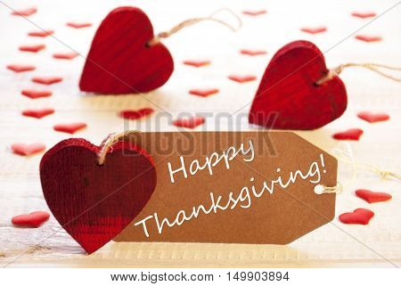 Label With English Text Happy Thanksgiving. Many Red Heart. Wooden Rustic Or Vintage Background.