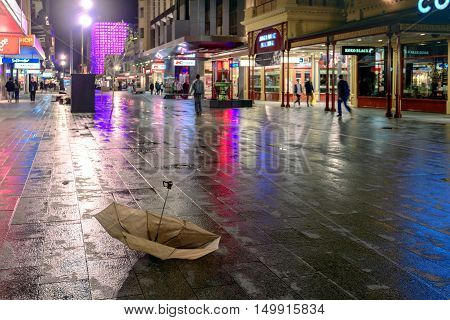 Adelaide Australia - August 11 2015: Broken umbrella after the rain lost by someone at Adelaide's famous Rundle Mall at night time