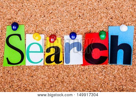 The Word Search In Cut Out Magazine Letters Pinned To A Cork Notice Board..