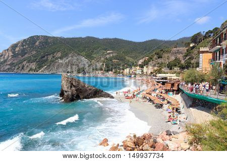 Monterosso, Italy - June 26, 2016: Beach at village Monterosso al Mare and Mediterranean Sea. Monterosso is one of the five villages in Cinque Terre.