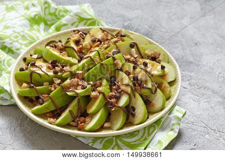 Loaded apple nachos with caramel, chocolate chips, granola and almonds