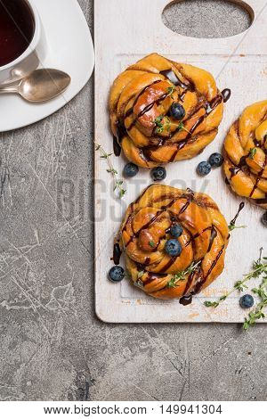 Homemade pumpkin cinnamon yeasted buns, fall baking concept, top view