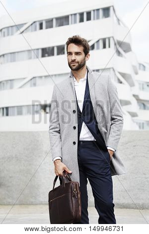 Good looking Bearded businessman with briefcase on location