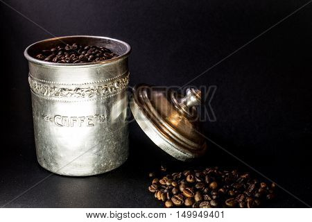 Coffee beans disposed on a dark background