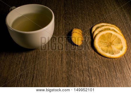 Ginger and lemon brewed natural medicine on a wooden background