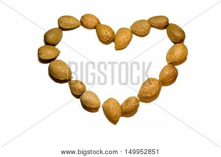 A hearted shap almonds in a white background