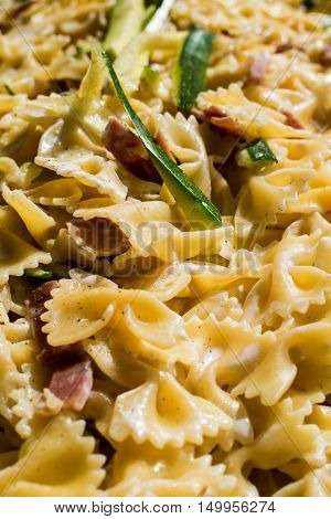 An italian recipe with pasta with zucchini and bacon