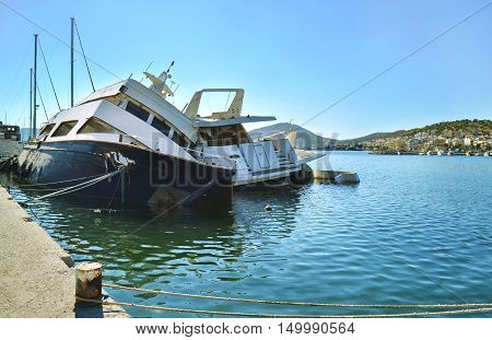 sunk boats at the port of Salamis Saronic gulf Greece