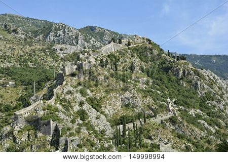 Part of the defensive hillside city walls above Kotor in Montenegro. The Our Lady of Remedy Church can be seen in the lower right.