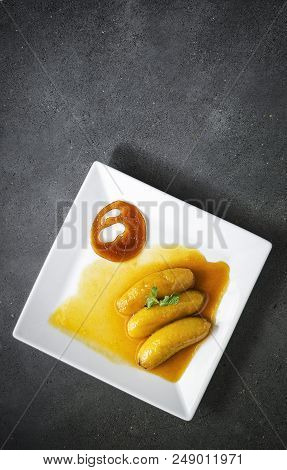 Gourmet Flambeed Fried Banana In Orange Juice Reduction Sauce And Tangerine Caramel Chip