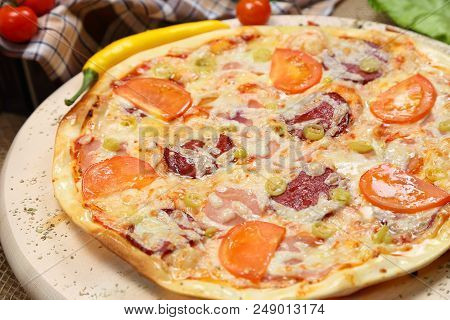 Pizza With Tomato, Cheese, Smoked Sausage, Boiled Sausage, Pepper Spices On A Wooden Tray Close-up