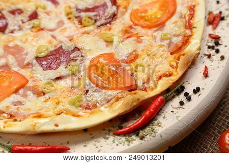 Pizza With Tomato, Cheese, Smoked Sausage, Boiled Sausage, Pepper Spices On A Wooden Tray Close-up