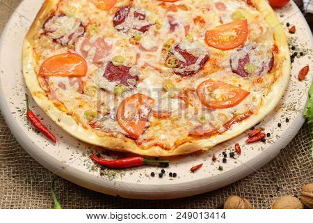 Pizza With Tomato, Cheese, Smoked Sausage, Boiled Sausage, Pepper Spices On A Wooden Tray Close-up