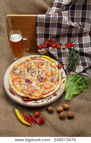 Pizza With Tomato, Cheese, Smoked Sausage, Boiled Sausage, Pepper Spices On A Wooden Tray, With Beer