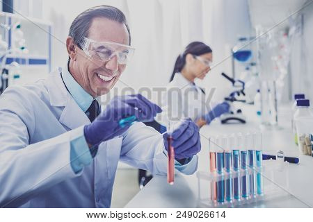 Beaming Bioengineer. Beaming Elderly Bioengineer Wearing Blue Gloves Feeling Amazing While Enjoying 