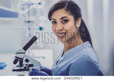 Inspired Bioengineer. Dark-haired Young Promising Bioengineer Feeling Very Inspired While Sitting Ne