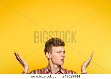 Uncomprehending Bewildered Puzzled Perplexed Confused Man Pointing Upwards With Hands. Portrait Of A