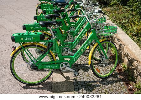 Berlin, Germany - July 2018: E-bikes, Many  Electric Bicycles Of Public Bike Sharing Company Limebik