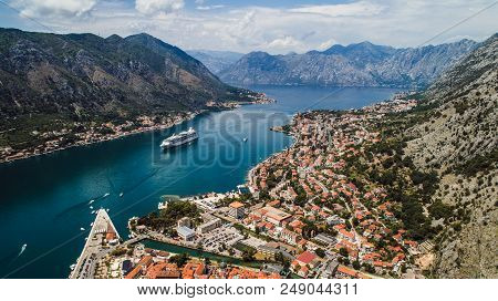 Aerial Beautiful View Of Kotor Bay. Cruise Ship Docked In Beautiful Summer Day. View Of Kotor Old To