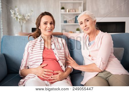 Mature Woman. Mature Blonde-haired Woman Coming For Visiting Her Young Friend Planning Childbirth