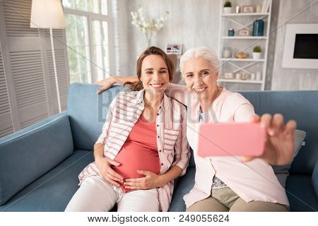 Modern Mother. Modern Mother Feeling Simply Amazing While Making Selfie With Her Pregnant Smiling Da